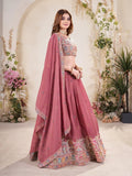 Woman wearing a light blue embroidered Lehenga with a matching blouse in a decorated indoor setting Glanzavi