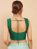 Green sleeveless top with open back on a beige background Glanzavi