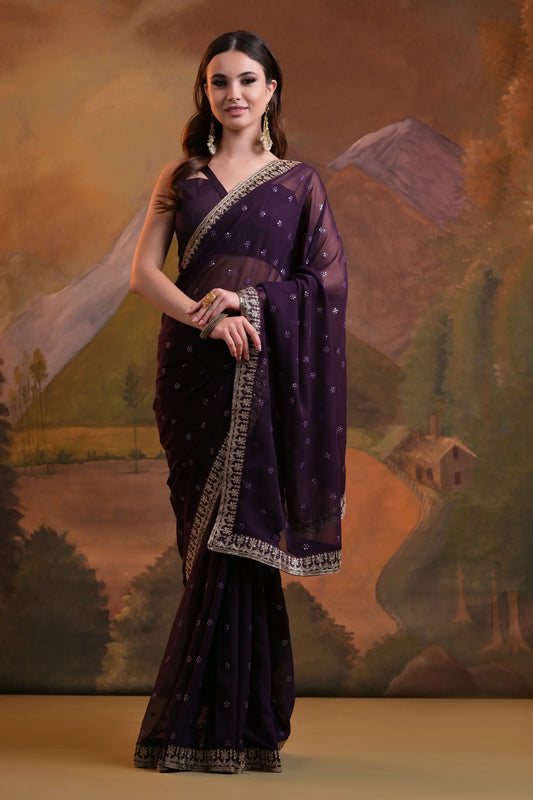 Woman wearing a traditional purple saree with a scenic background Glanzavi