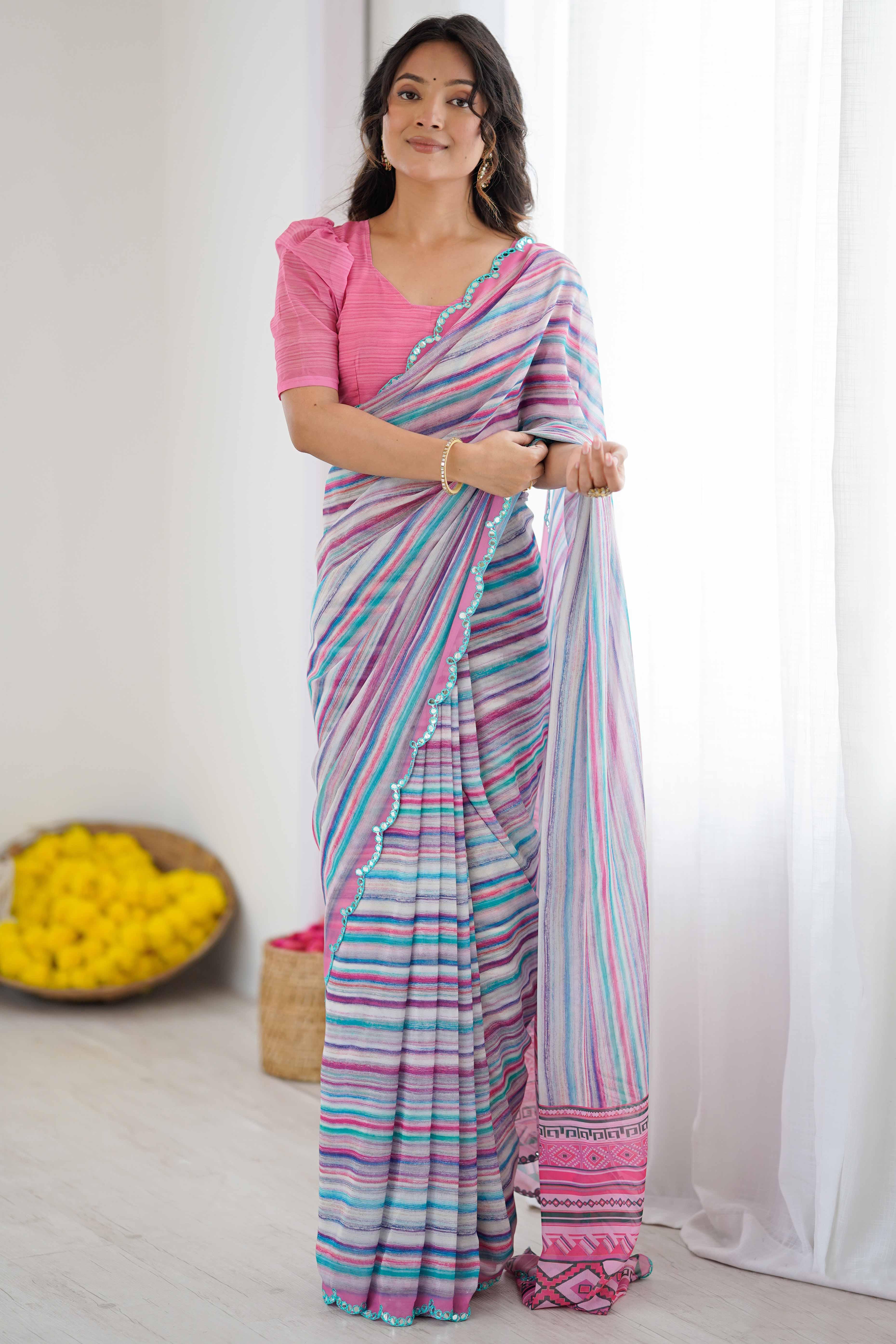 Woman wearing a colorful saree with a pink blouse against a white background Glanzavi