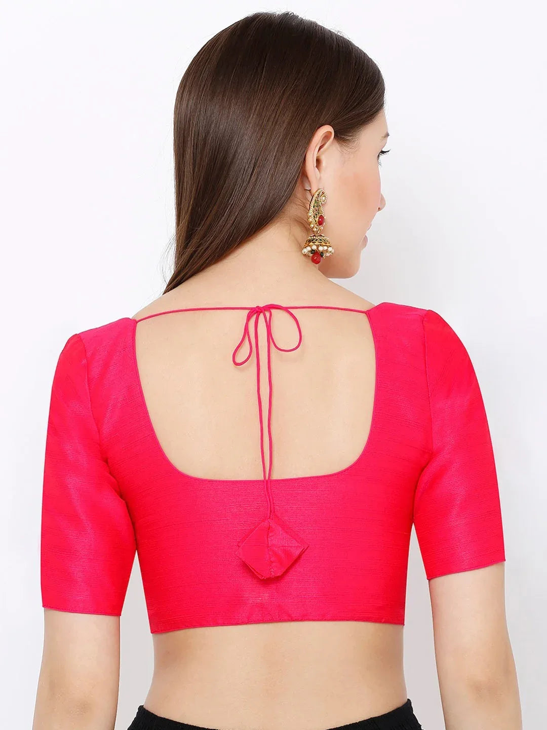 Woman wearing a bright pink blouse with a unique back design on a white background Glanzavi