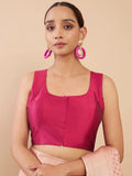 Woman wearing a bright pink blouse with a beige background Glanzavi