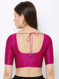 Woman wearing a bright pink blouse with a unique back design on a white background Glanzavi