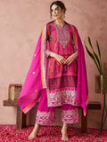 Woman in a pink traditional outfit with intricate patterns on a pink background Glanzavi