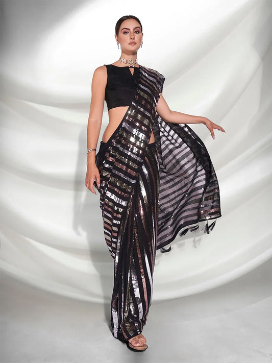 Woman wearing a black and silver saree against a white background Glanzavi