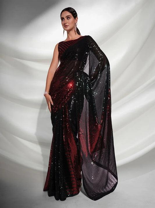 Woman wearing a black and red saree with a white draped background Glanzavi