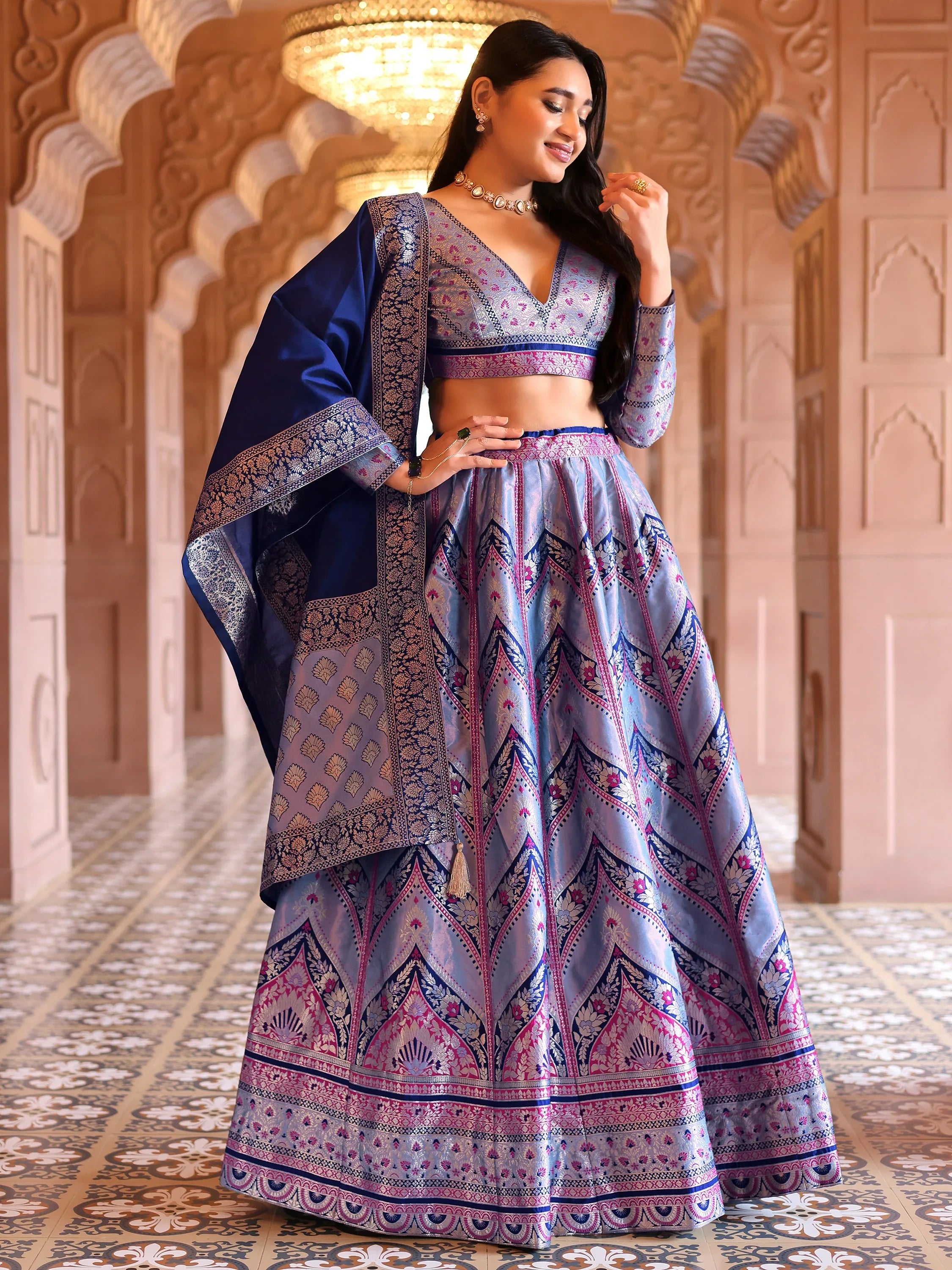 Woman in a traditional outfit with intricate patterns in a decorative interior setting Glanzavi