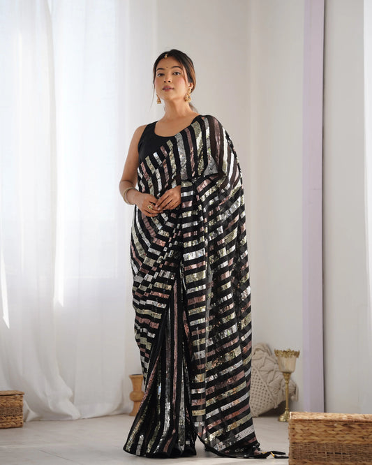 A woman modeling a black saree with multicolor striped sequin embroidery and a solid black blouse Glanzavi
