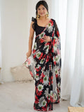 Woman wearing a black floral saree in a bright room Glanzavi