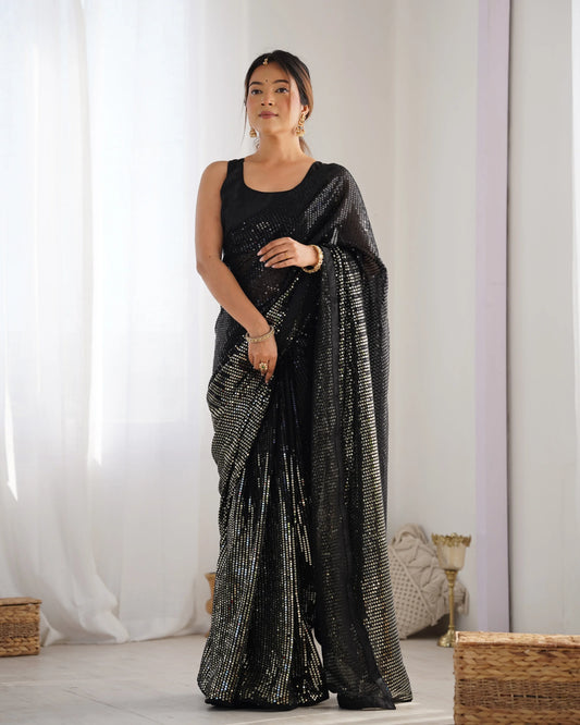Woman wearing a black saree with silver patterns in a minimalistic setting Glanzavi