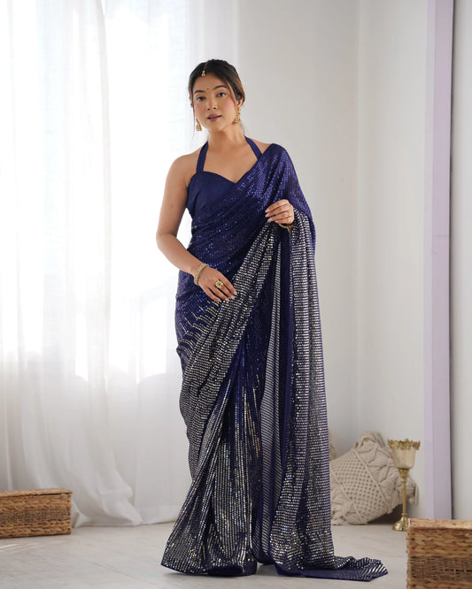 Woman wearing a blue saree with a white background Glanzavi