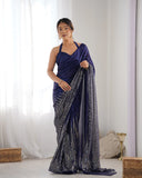 Woman wearing a blue saree with a white background Glanzavi