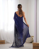 Woman wearing a blue saree with a white background Glanzavi
