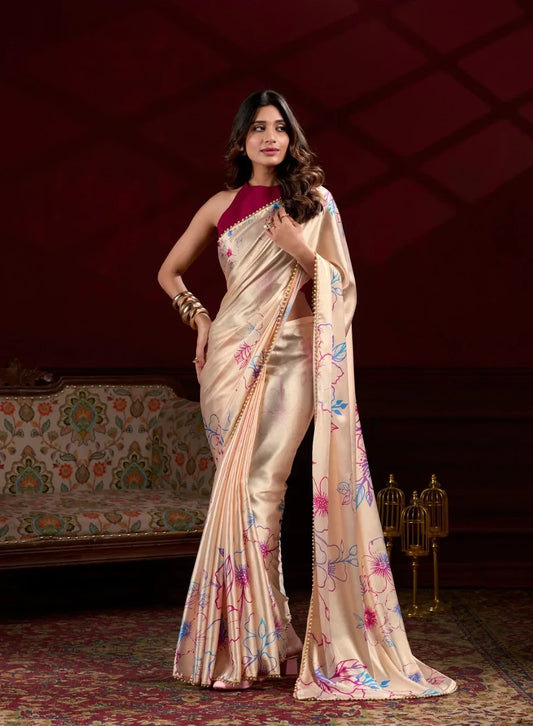 Woman in a beige saree with floral patterns in an elegant indoor setting Glanzavi