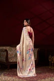 Woman wearing a floral saree in an elegant room setting Glanzavi