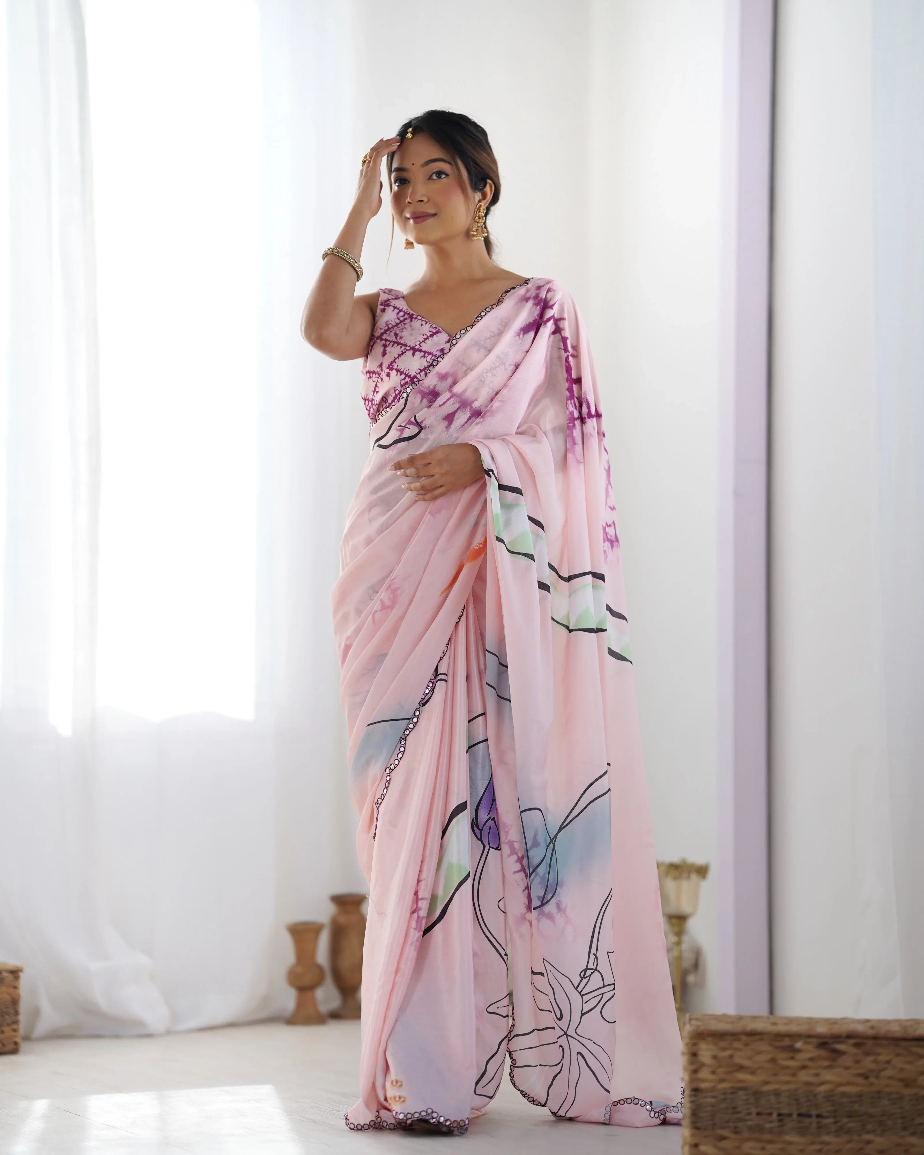 Woman wearing a pink floral saree in a minimalistic setting Glanzavi