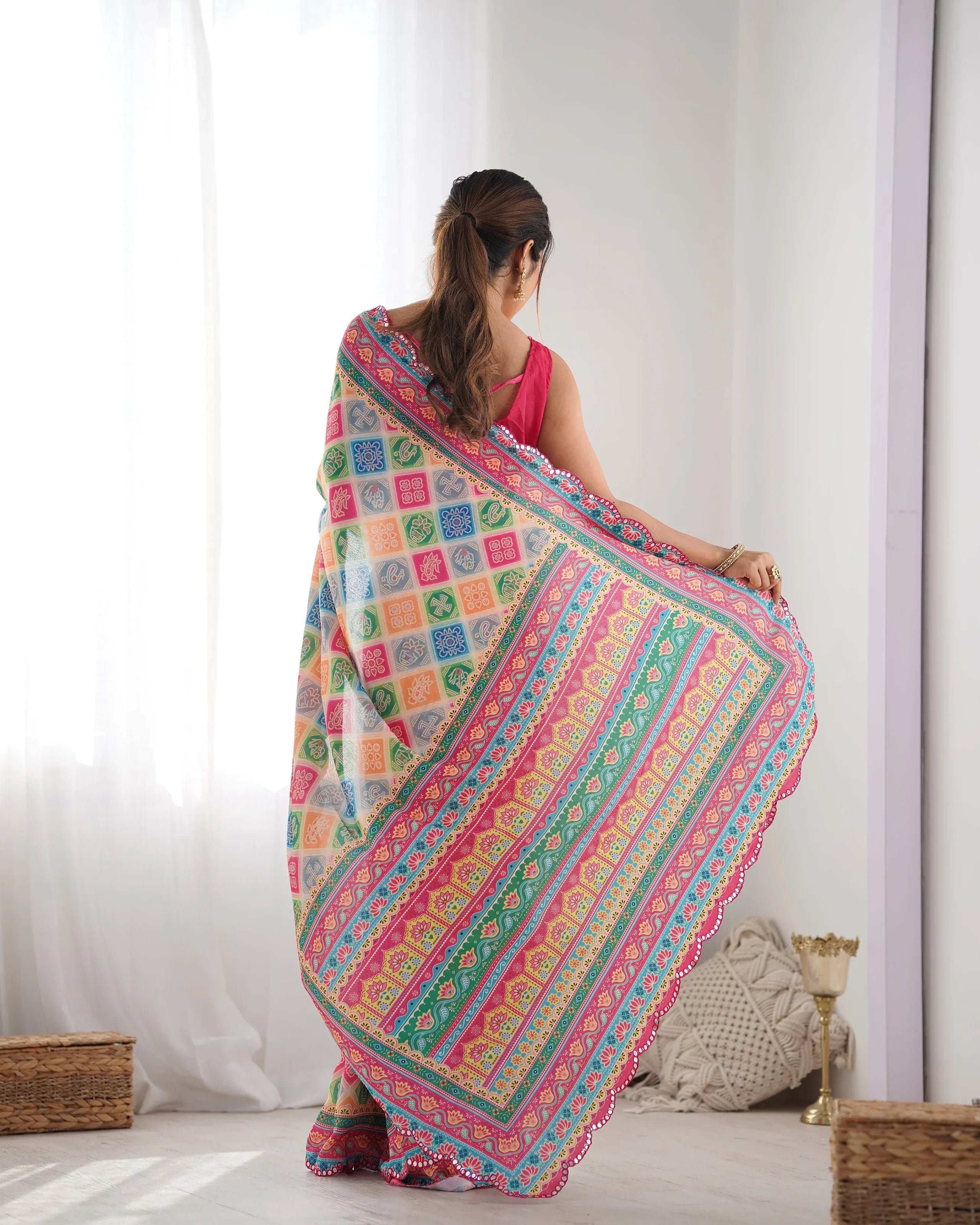 Woman wearing a colorful patterned saree in a bright room Glanzavi