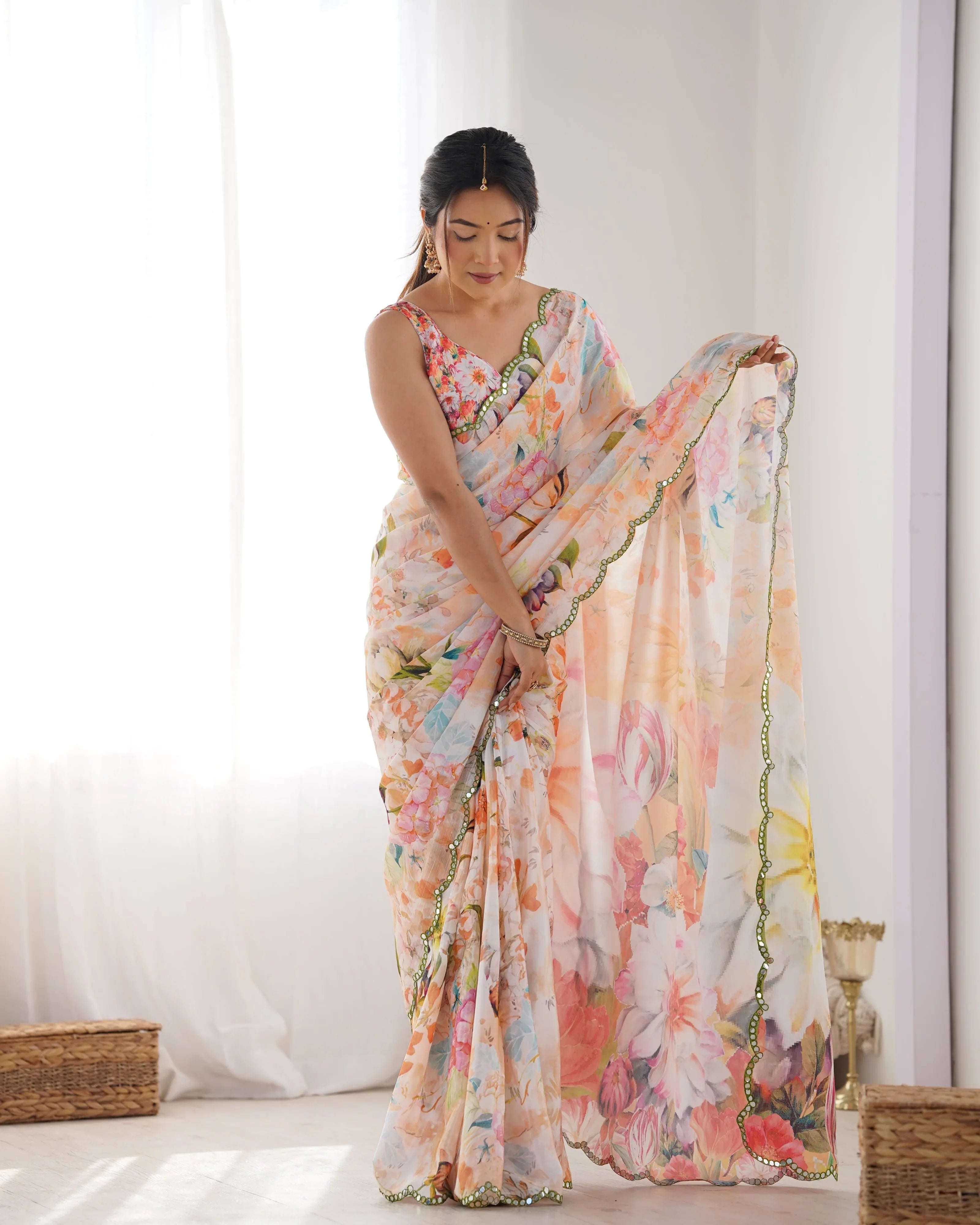 Woman wearing a floral saree in a minimal indoor setting Glanzavi