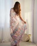 Woman holding a colorful floral and paisley patterned scarf in a bright room Glanzavi