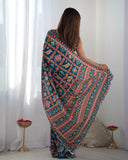 Woman wearing a colorful patterned saree in a minimalistic room Glanzavi