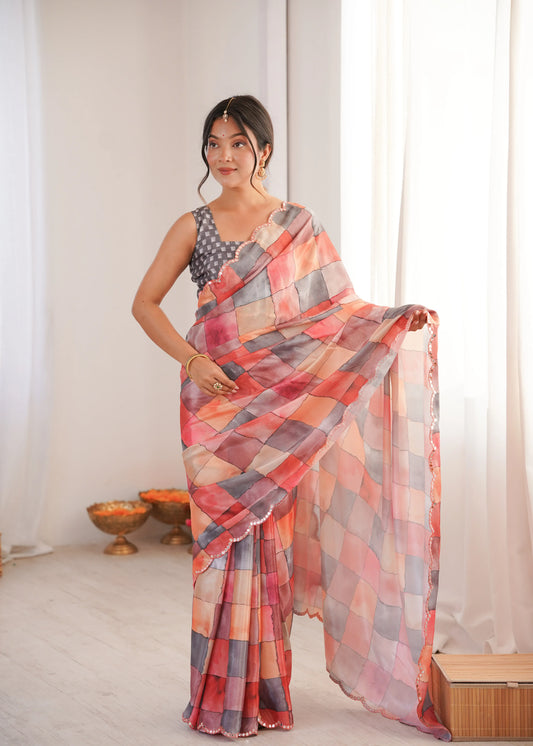 Woman wearing a colorful saree in a room with white curtains and a small table Glanzavi.