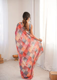Woman wearing a colorful checkered saree in a room with white curtains Glanzavi.