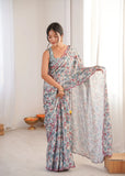Woman wearing a floral saree in a minimalistic room Glanzavi.