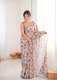 Woman wearing a patterned saree in a minimal indoor setting Glanzavi