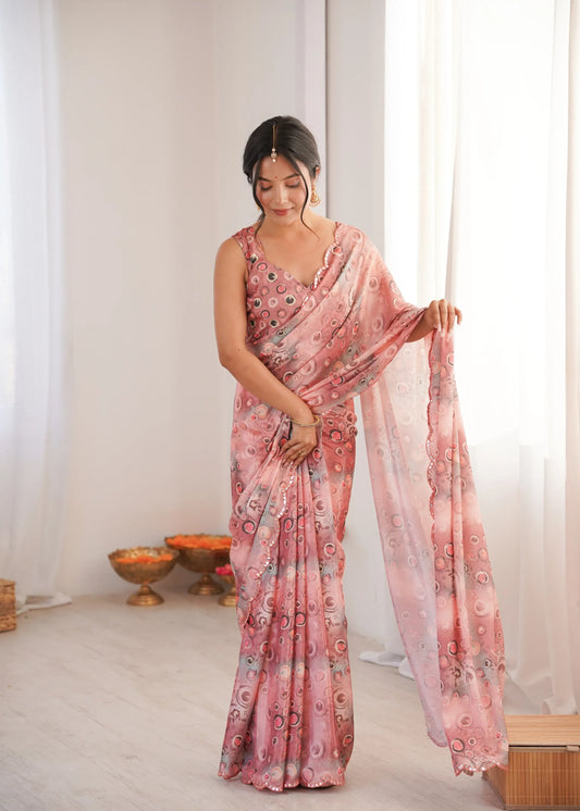 Woman wearing a pink saree with a pattern in a room with white curtains Glanzavi.