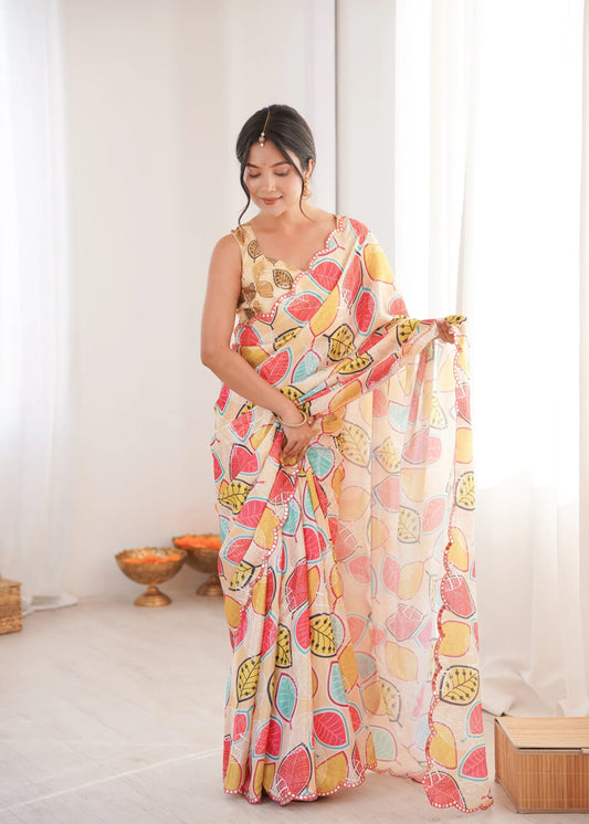 Woman wearing a colorful patterned saree in a bright room Glanzavi.