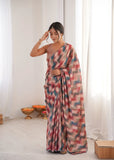 Woman wearing a colorful saree in a minimal indoor setting Glanzavi