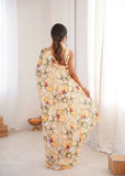 Woman wearing a floral dress in a bright room with white curtains Glanzavi.