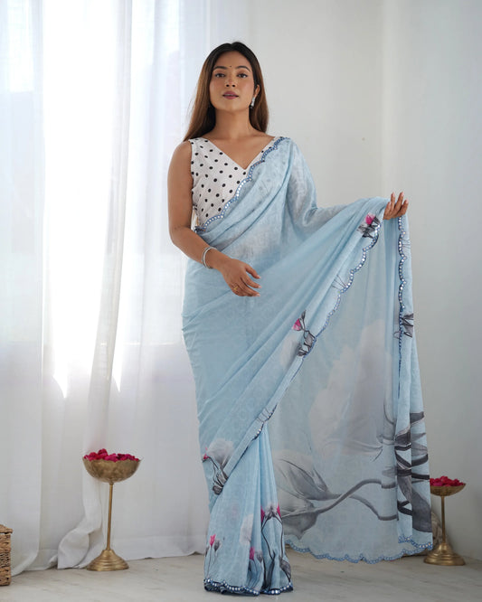 Woman wearing a light blue saree with a white background Glanzavi