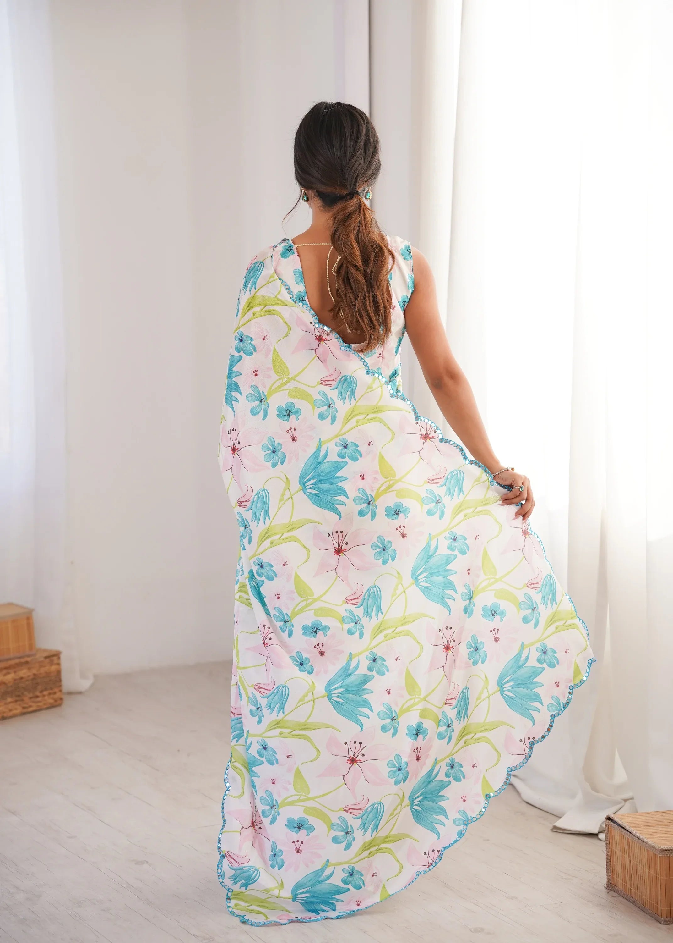 Woman wearing a floral dress in a minimal indoor setting Glanzavi