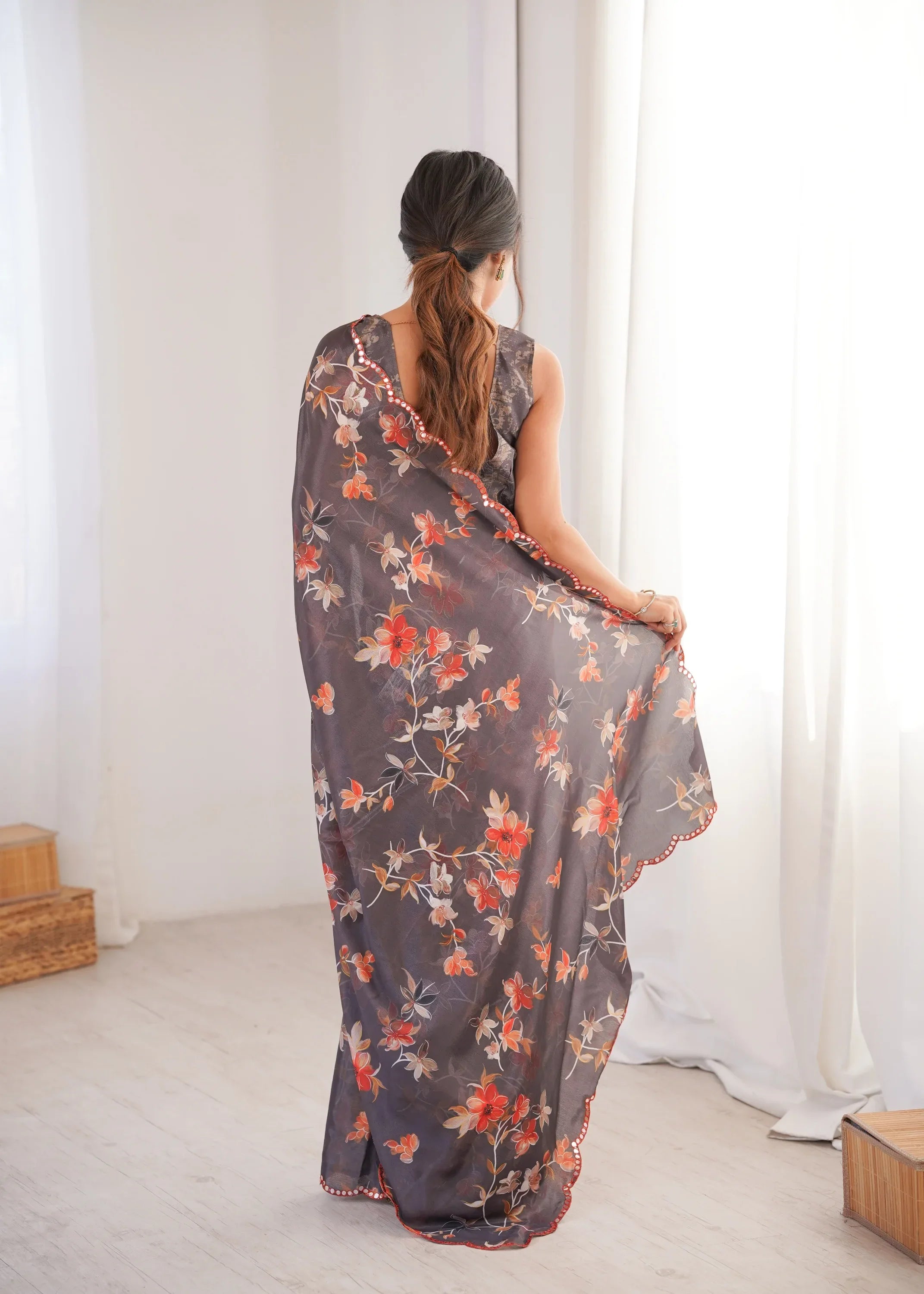 Woman wearing a floral dress in a minimal white room Glanzavi