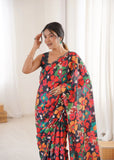 Woman wearing a colorful floral saree in a bright room.-glanzavi