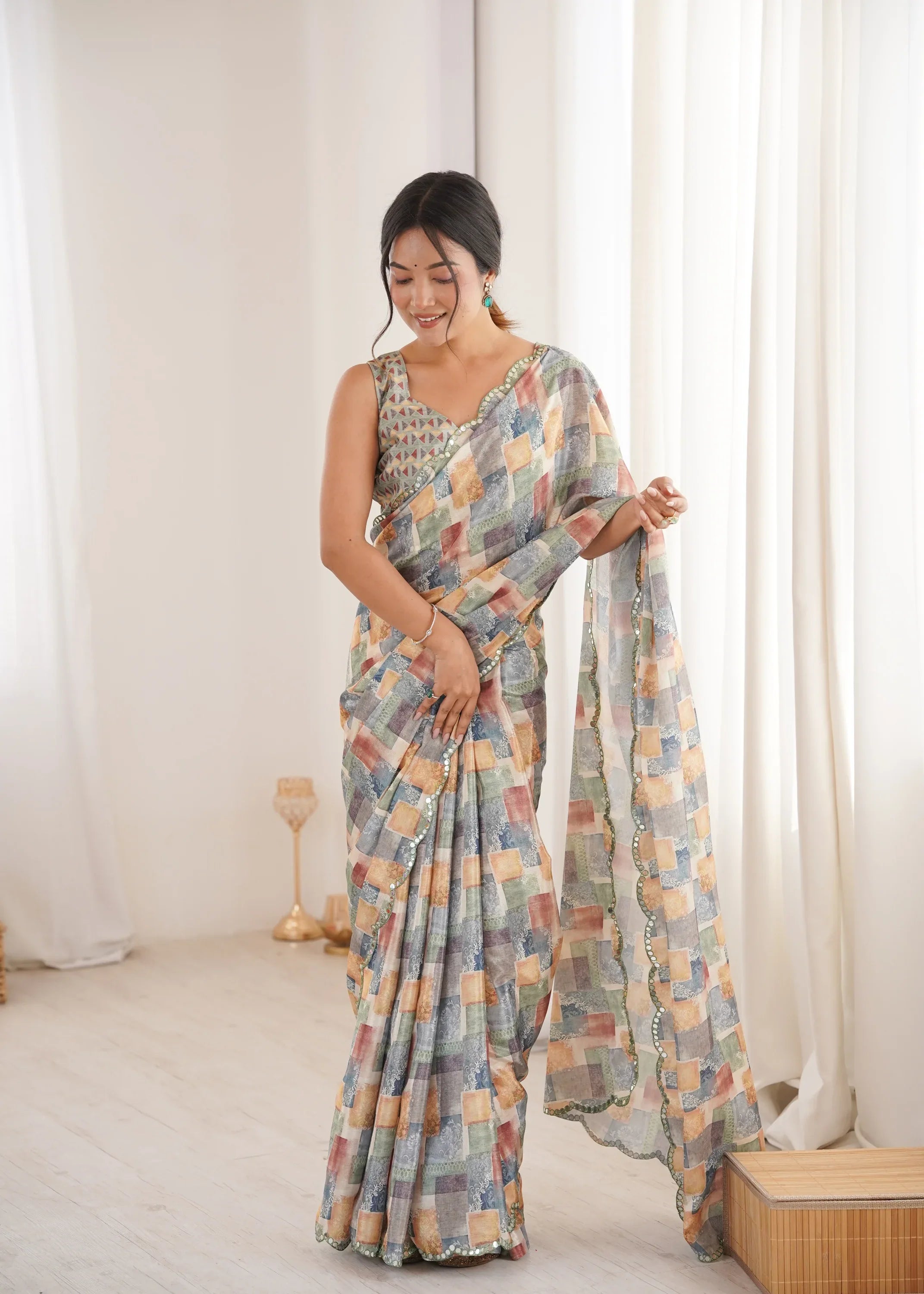 Woman wearing a multicolored saree in a bright room with white curtains Glanzavi