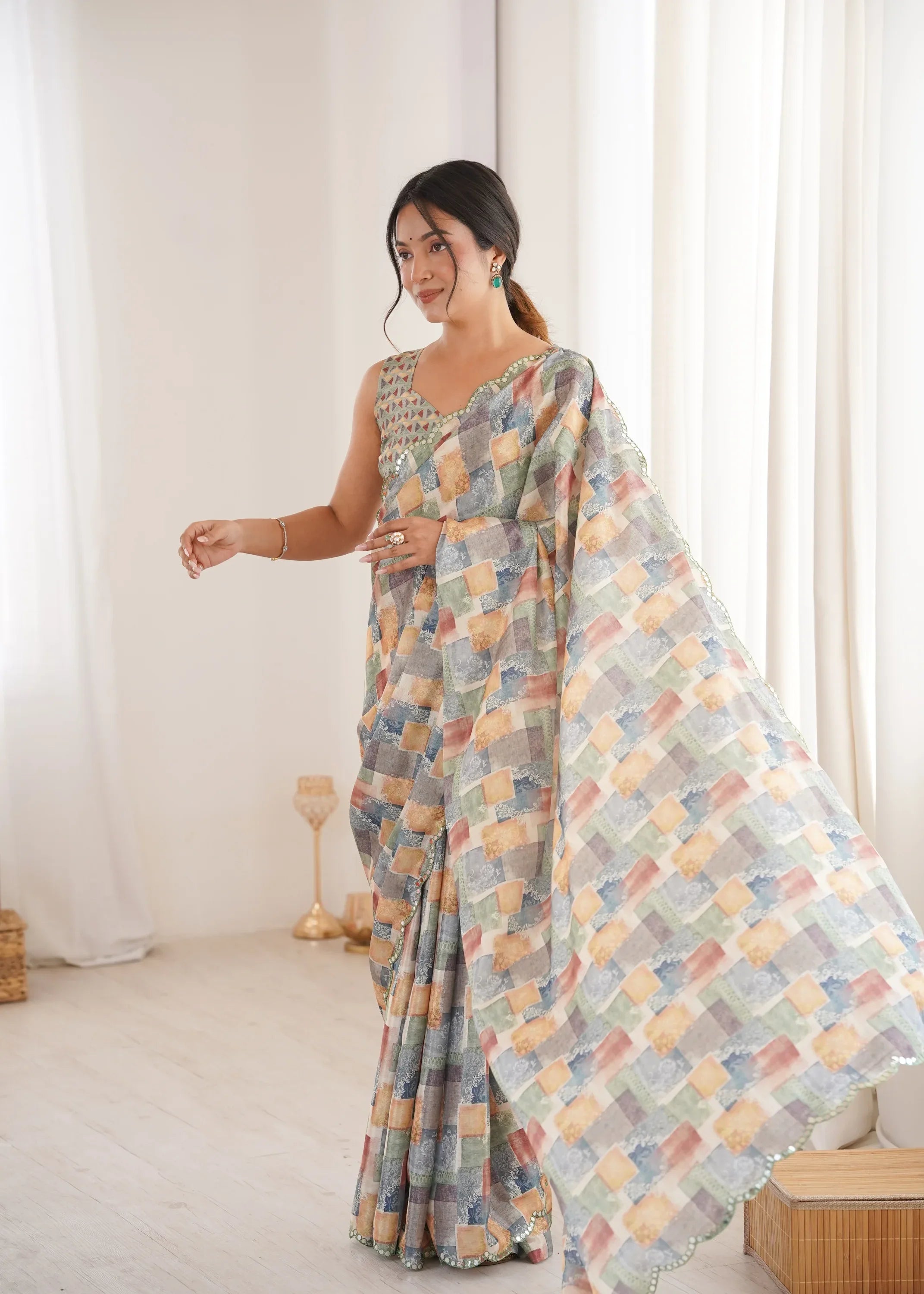 Woman wearing a patterned saree in a minimal indoor setting Glanzavi