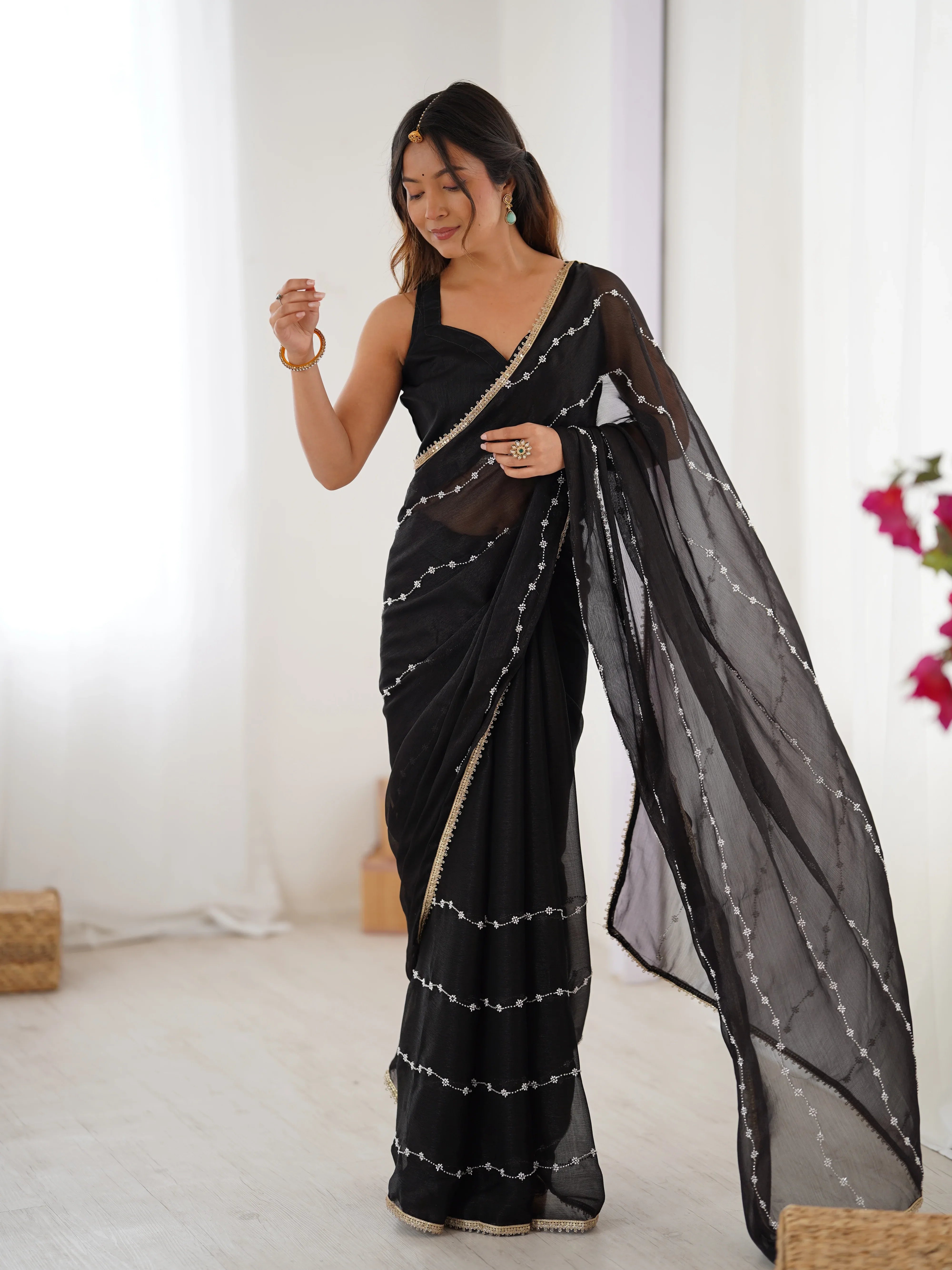 Woman wearing a black saree with silver details in a minimal indoor setting Glanzavi