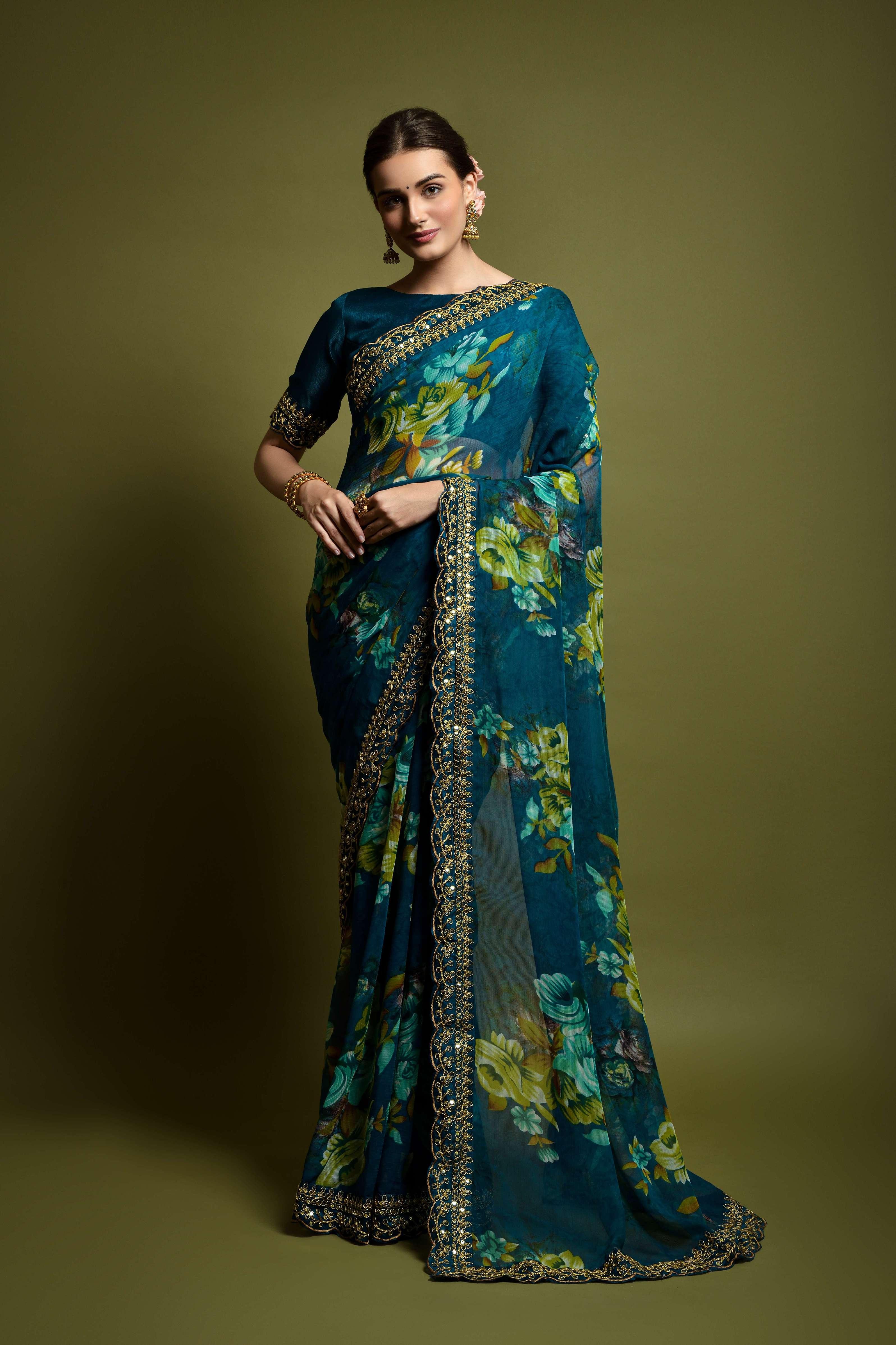 Woman wearing a blue floral saree against a green background Glanzavi