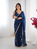 Woman wearing a blue saree with a white background Glanzavi