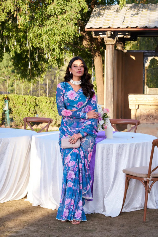 Woman in a floral dress standing outdoors at a formal event Glanzavi.