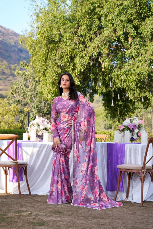 Woman in a floral saree standing in front of a decorated outdoor table with flowers and candles Glanzavi.