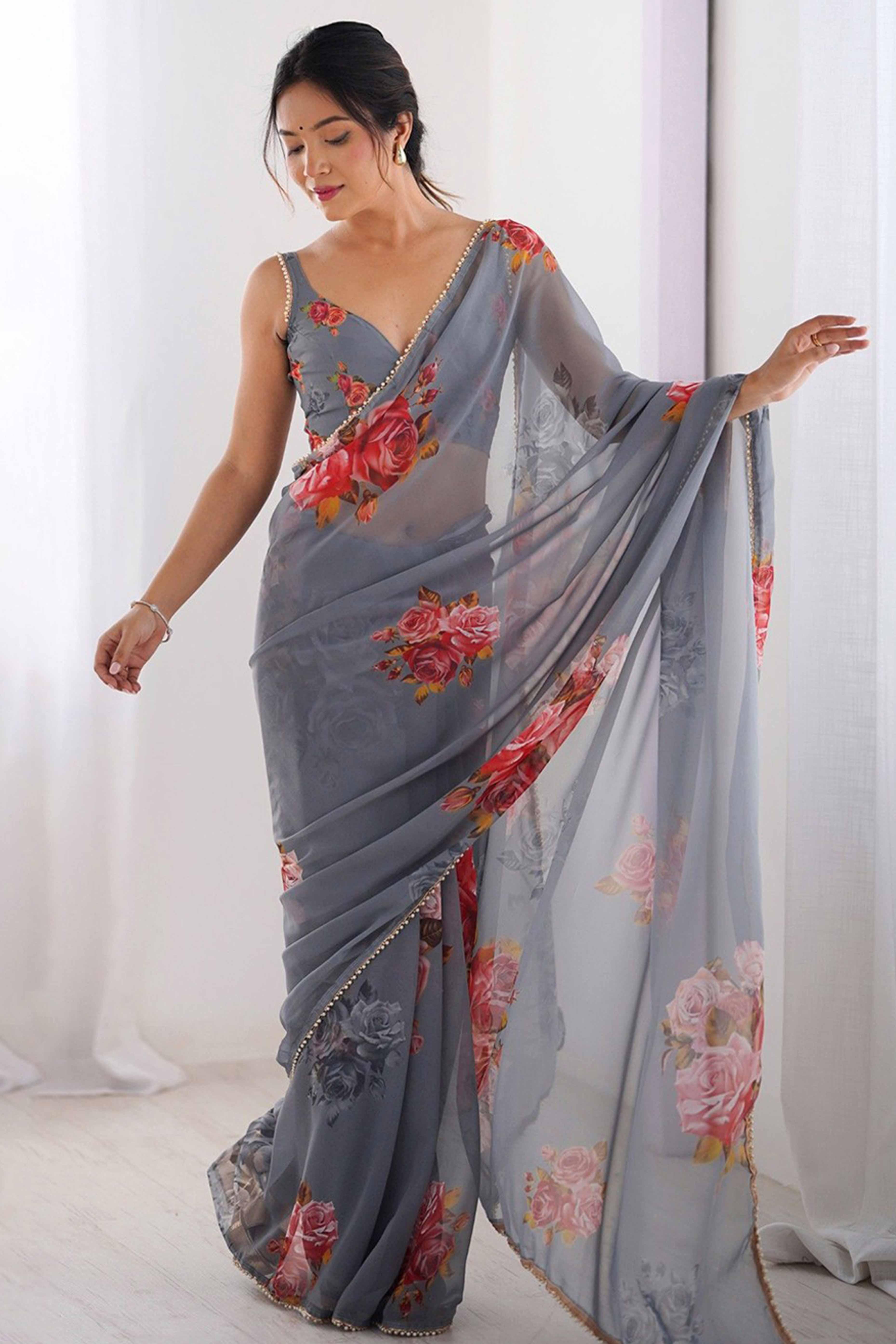 Woman wearing a gray saree with floral patterns against a white background Glanzavi