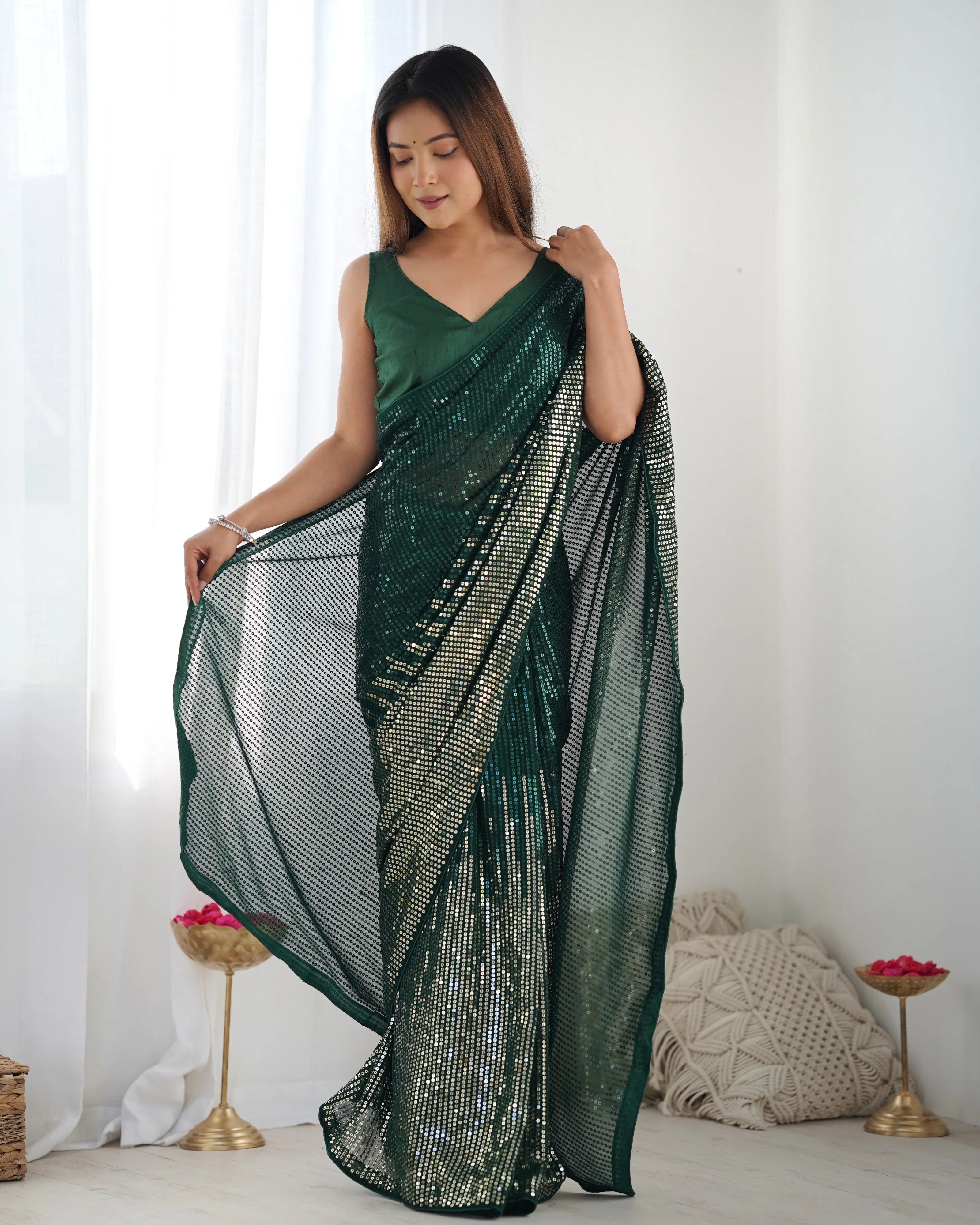 Woman wearing a green saree with a white background Glanzavi