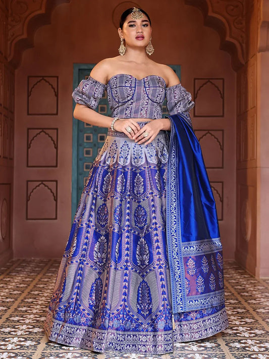 Woman in a traditional blue and silver embroidered outfit with a matching shawl indoors Glanzavi.