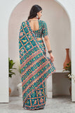 Woman wearing a colorful saree with a pattern in a minimalistic setting Glanzavi