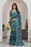 Woman wearing a green saree with a pattern in an indoor setting Glanzavi