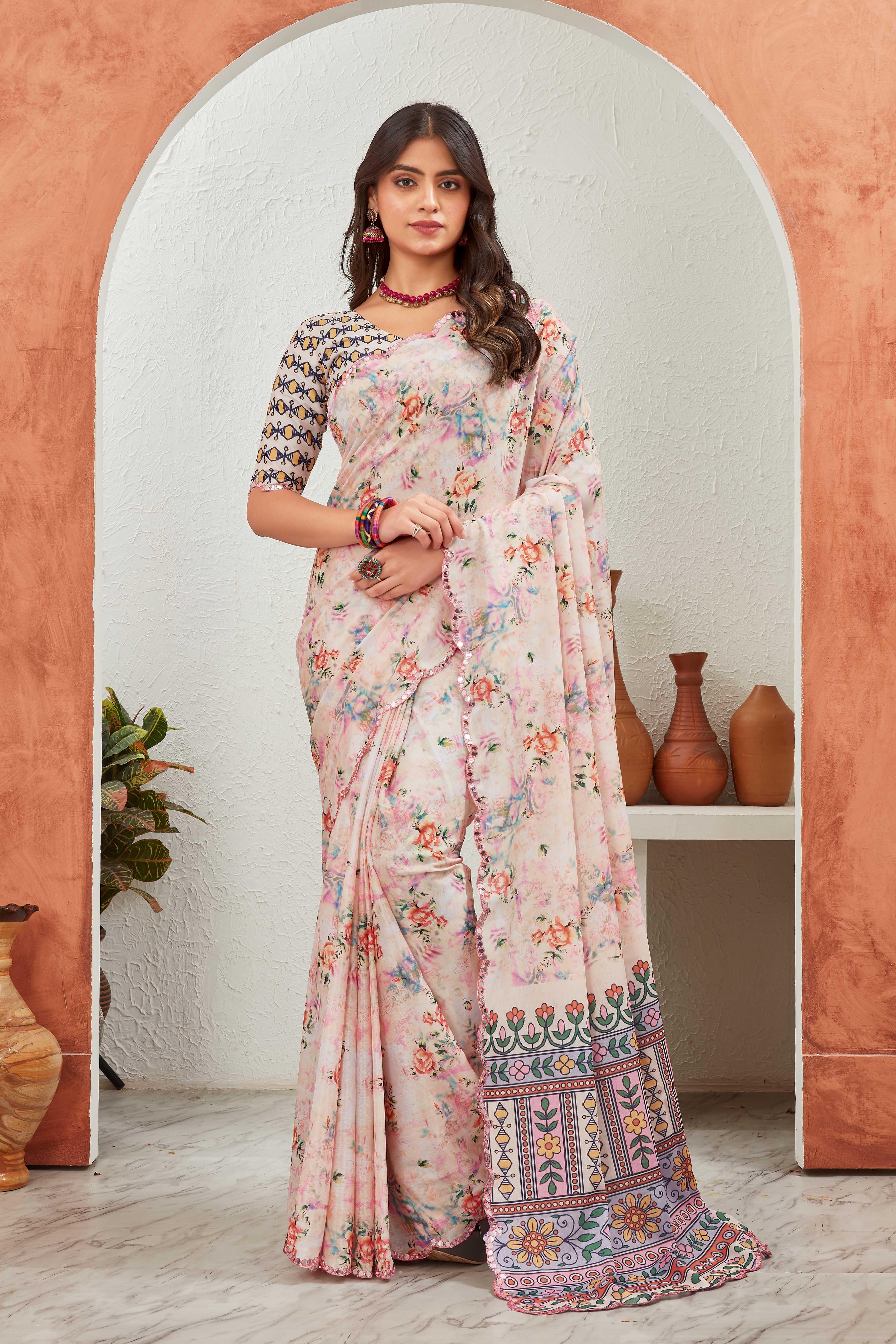Woman wearing a floral saree standing in front of an archway with decorative vases Glanzavi