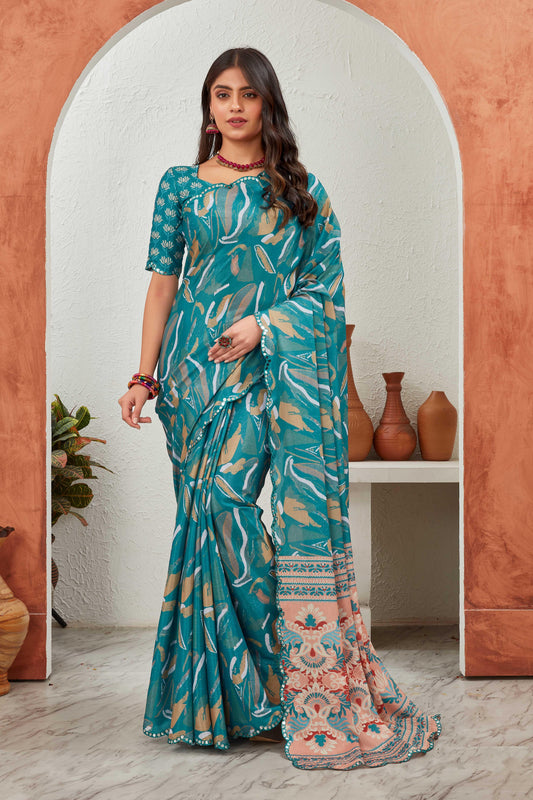 Woman wearing a teal saree with a floral blouse in a decorative setting Glanzavi
